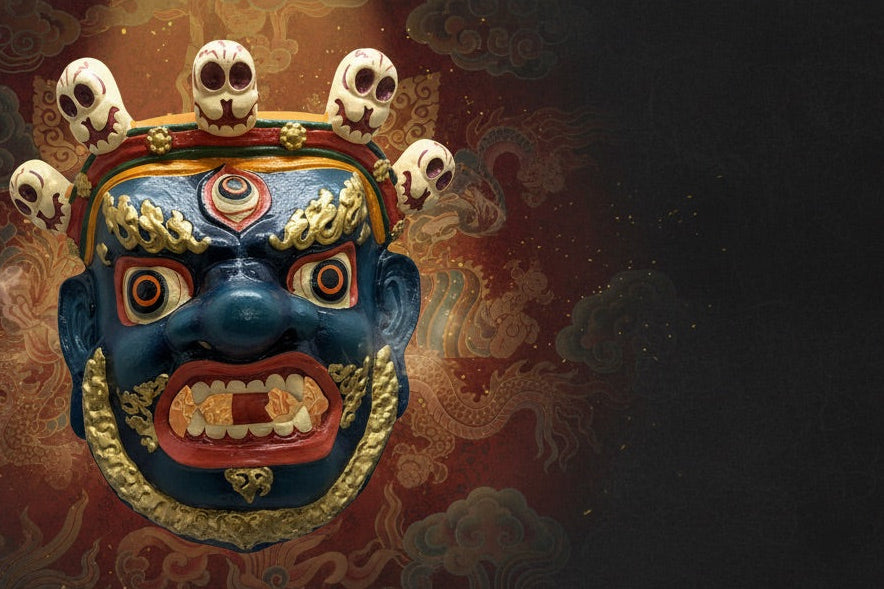 Decorative mask with blue face and gold accents on a dark background